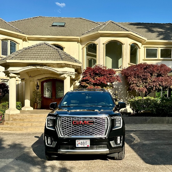 black SUV parked in front of house
