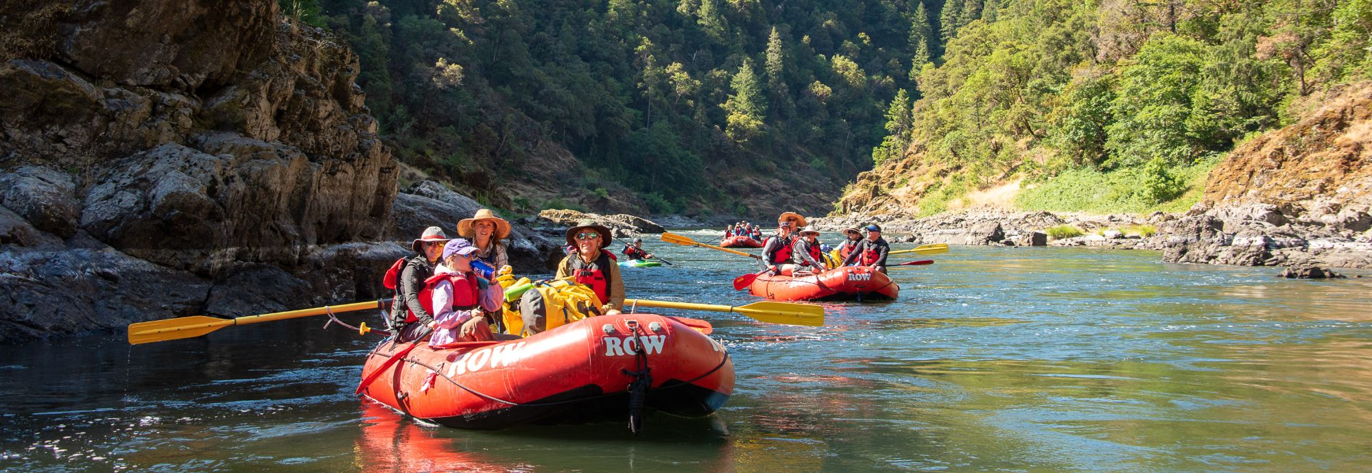 people on rafting trip floating down a river