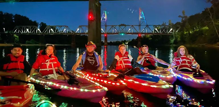 kayakers at night with lights