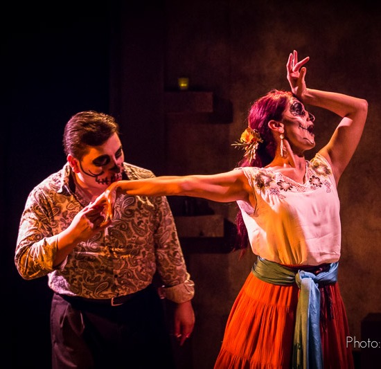 two people in costume with faces painted on stage acting