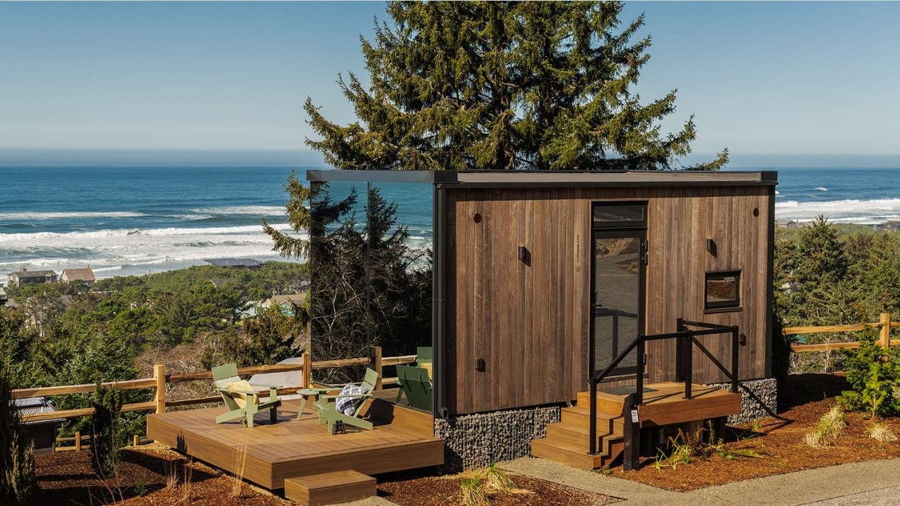 exterior view of mirror cabin with ocean in background