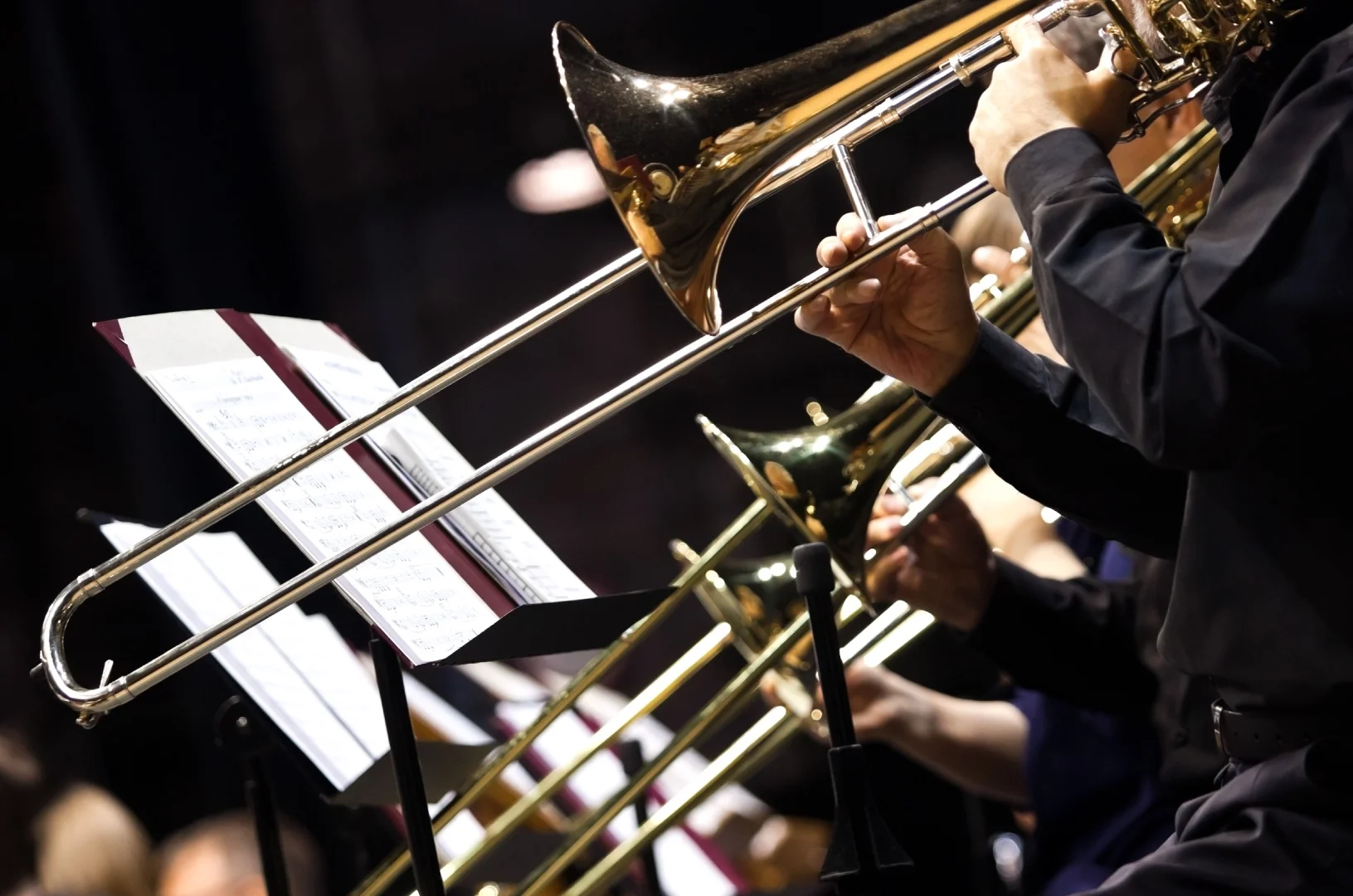 Close up of musicians playing trombones