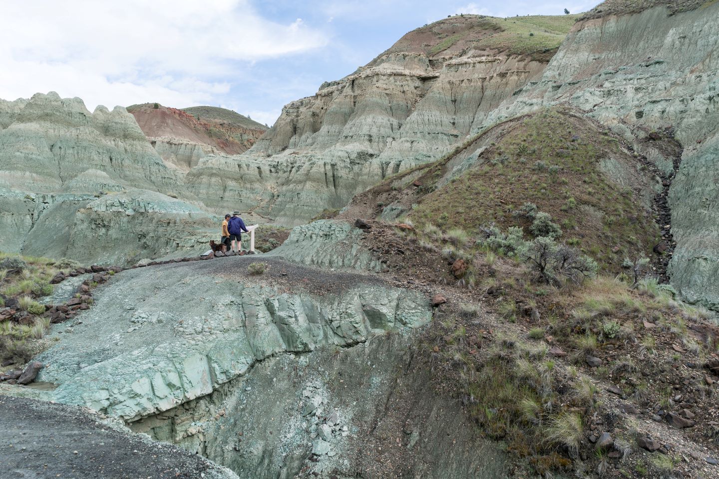 people hiking through a beautiful blue green rocky terrain