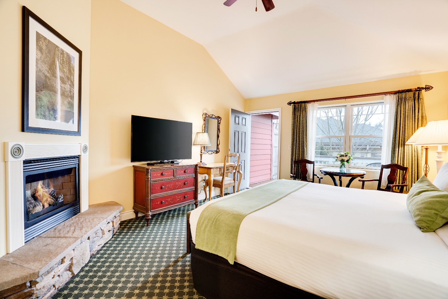 interior hotel room with one bed and fireplace
