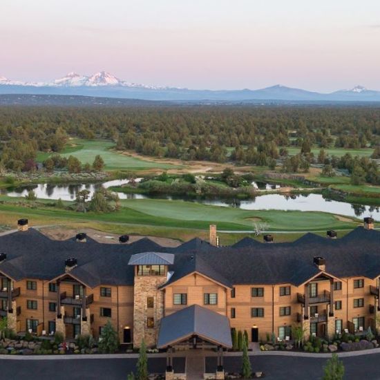 lodge in foreground with golf course and cascade mountains in background