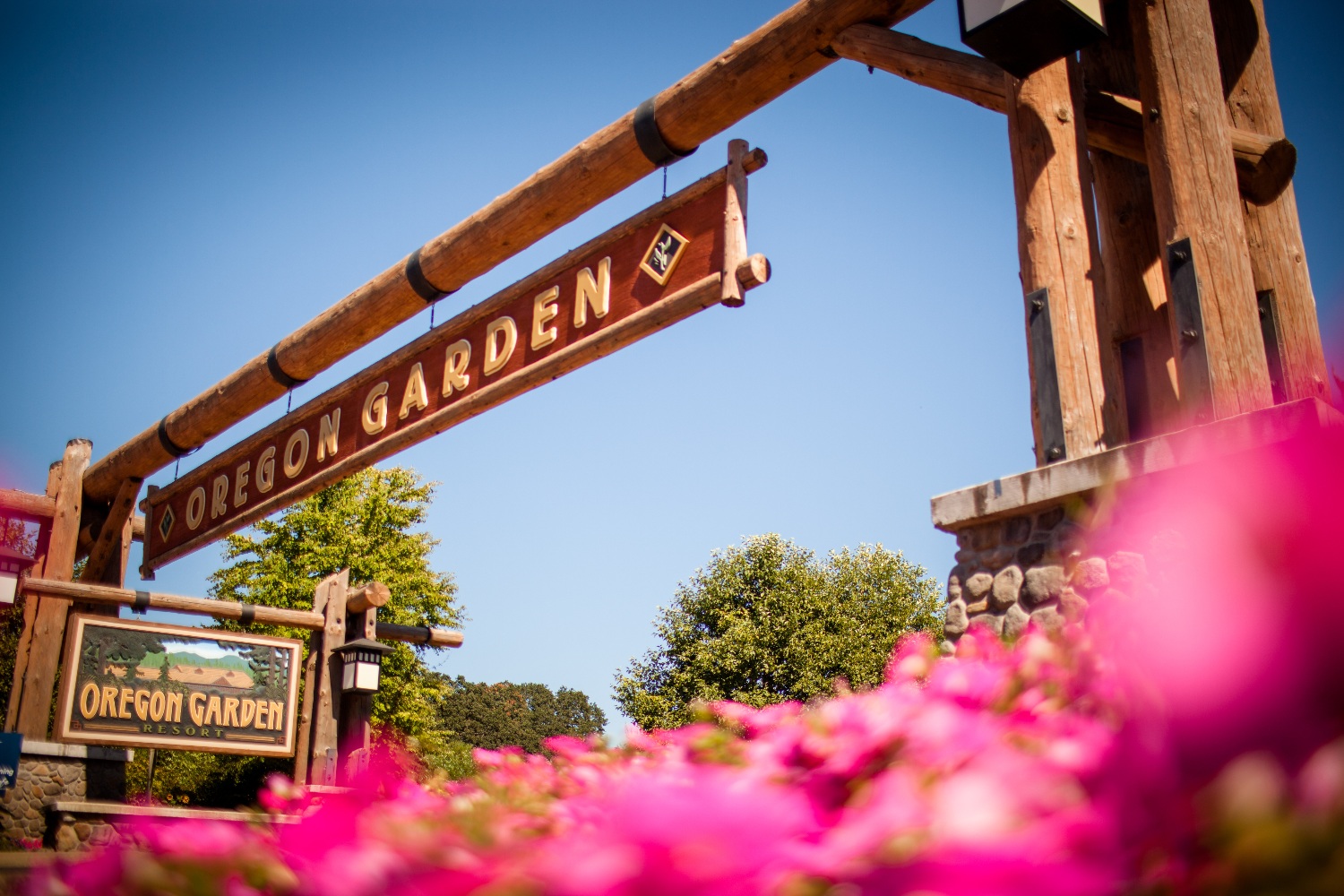 Oregon Garden Resort sign with pink flowers in the foreground