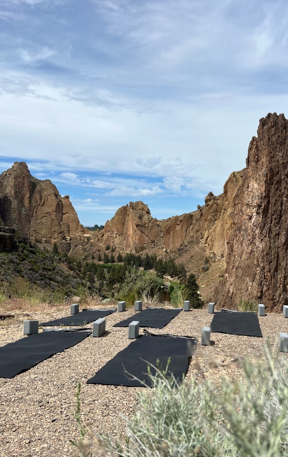 Smith Rock State PArk with yoga mats and yoga blocks laid out on the ground