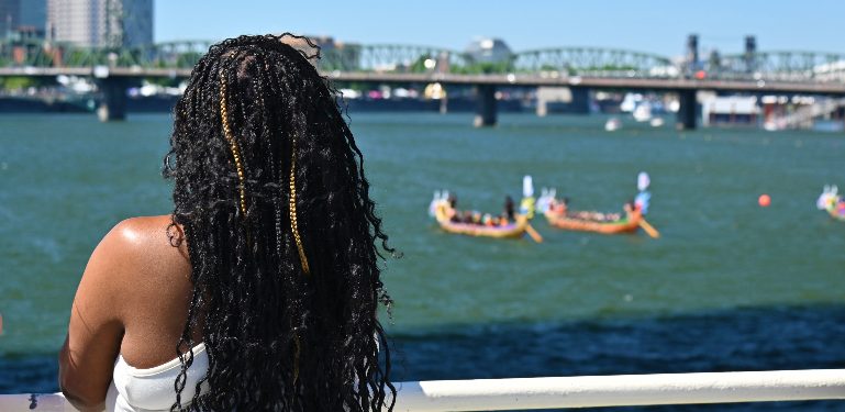 person looking out over river from deck of boat