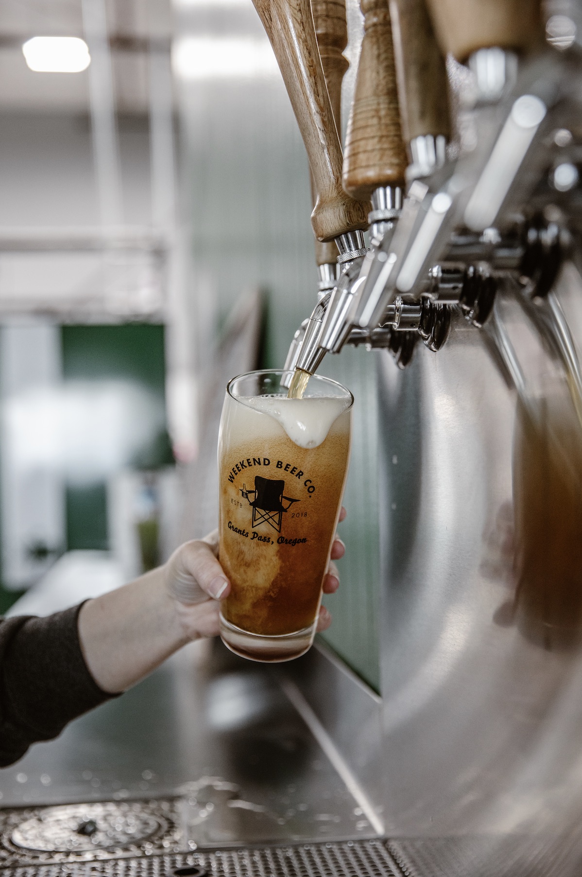 Weekend Beer pint glass being filled on tap