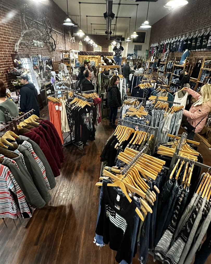 racks of close inside retail clothing business with brick walls