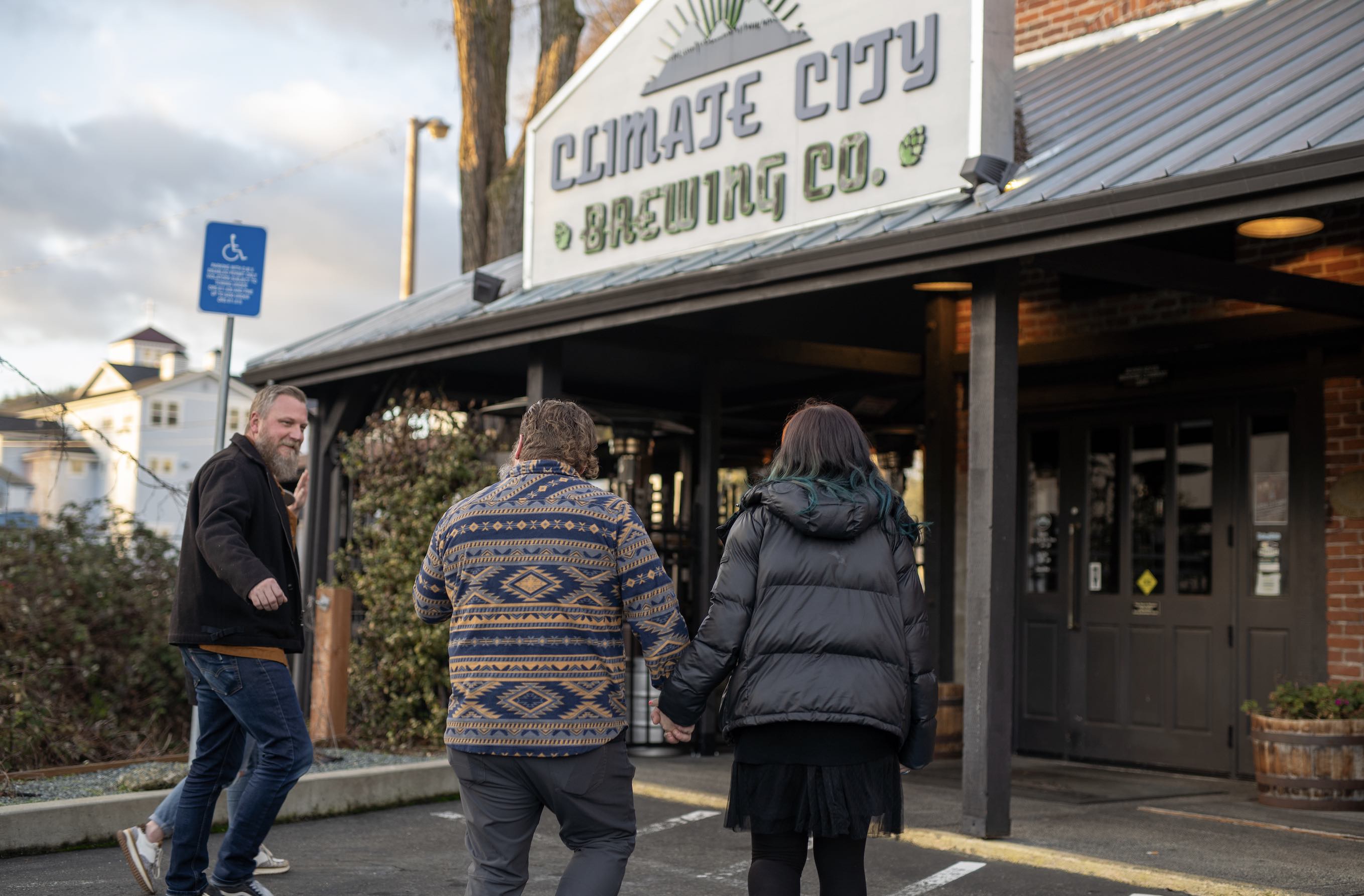 A group of people have a conversation as they approach Climate City