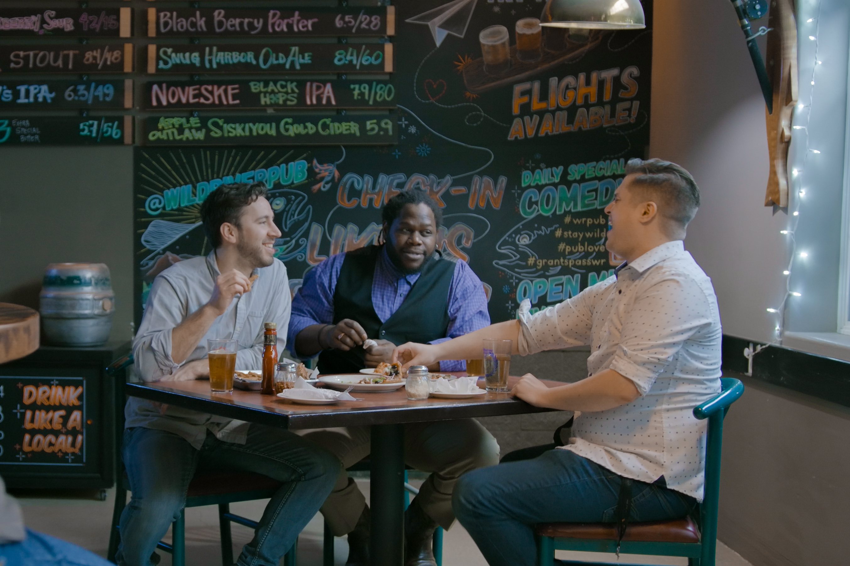 Wildriver Brewing, group enjoys pizza in front of the specials board