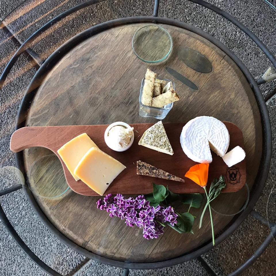 tray of a variety of cheeses atop a small table