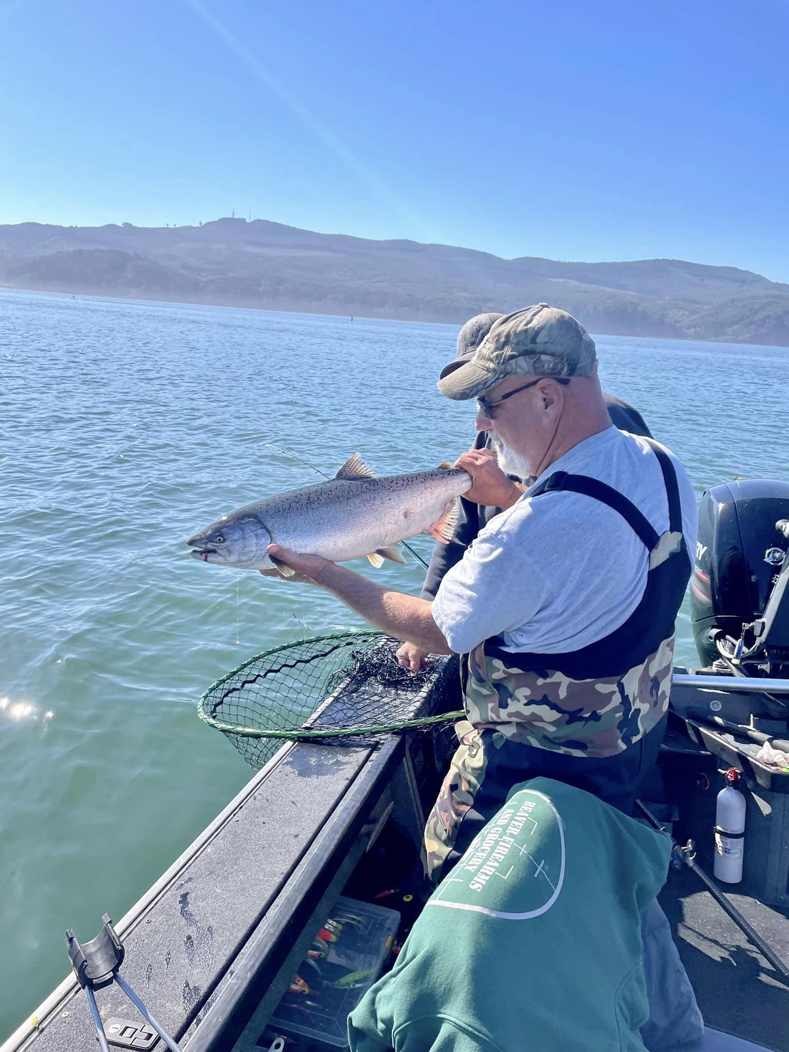 Fisherman holding a salmon they just caught