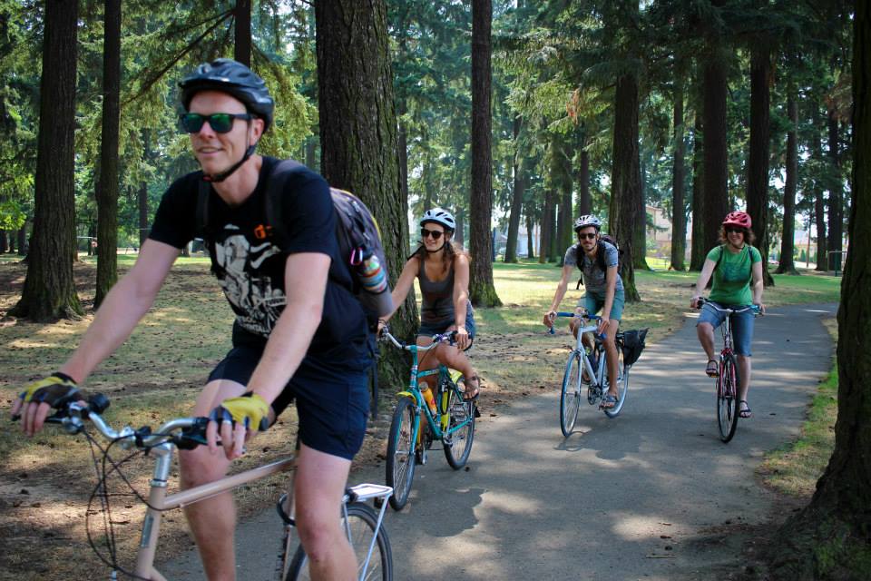 Four bike riders enjoy the park setting.