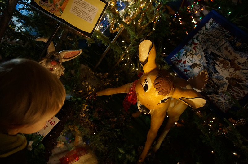a child looking at a model of Bambi from the Disney film