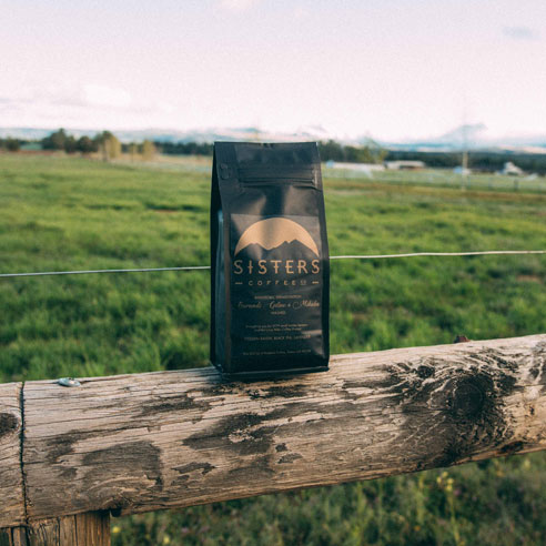 ground coffee bag on fence