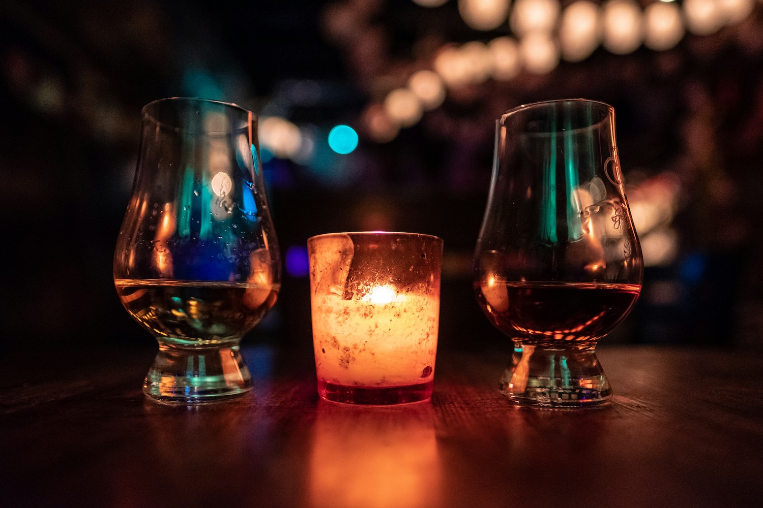 two whiskey glasses with candle