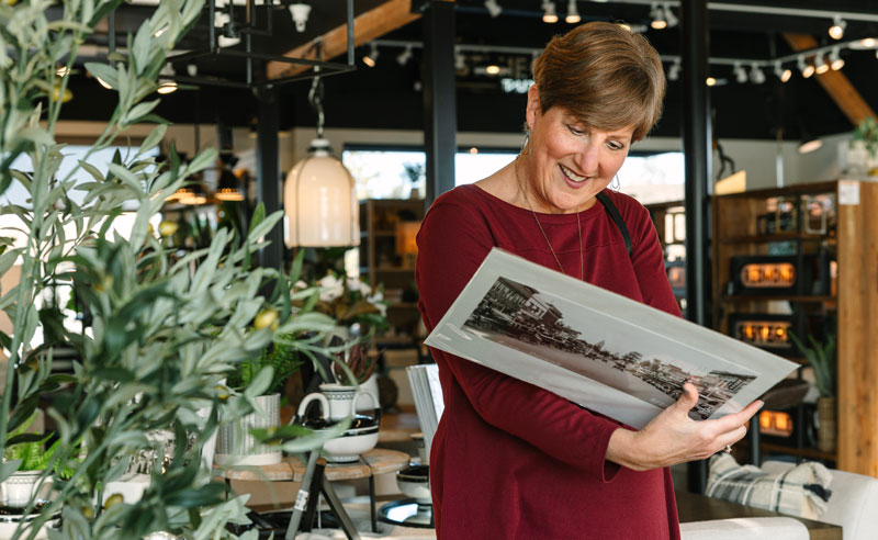woman looking at the back of a photograph print
