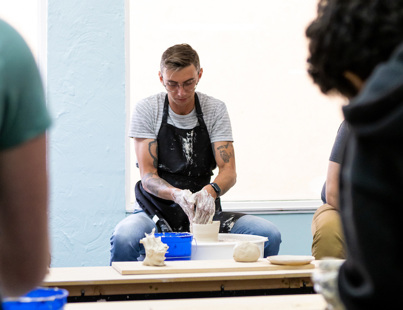 student learning ceramics in a studio