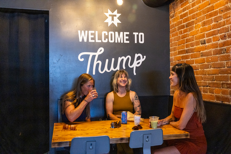 three friends getting coffee at Thump