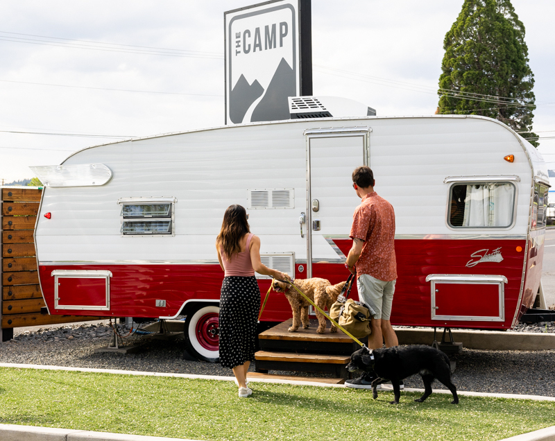 couple with dogs at a trailer door