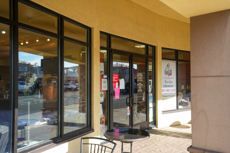 storefront of coffee shop with table and chair in front