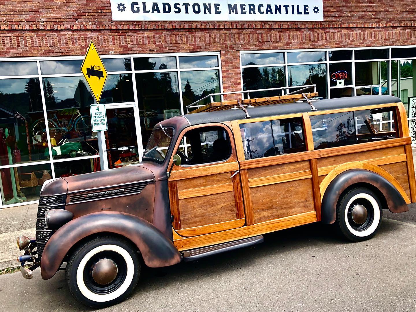 An antique wooden truck sits in front of Gladstone Mercantile
