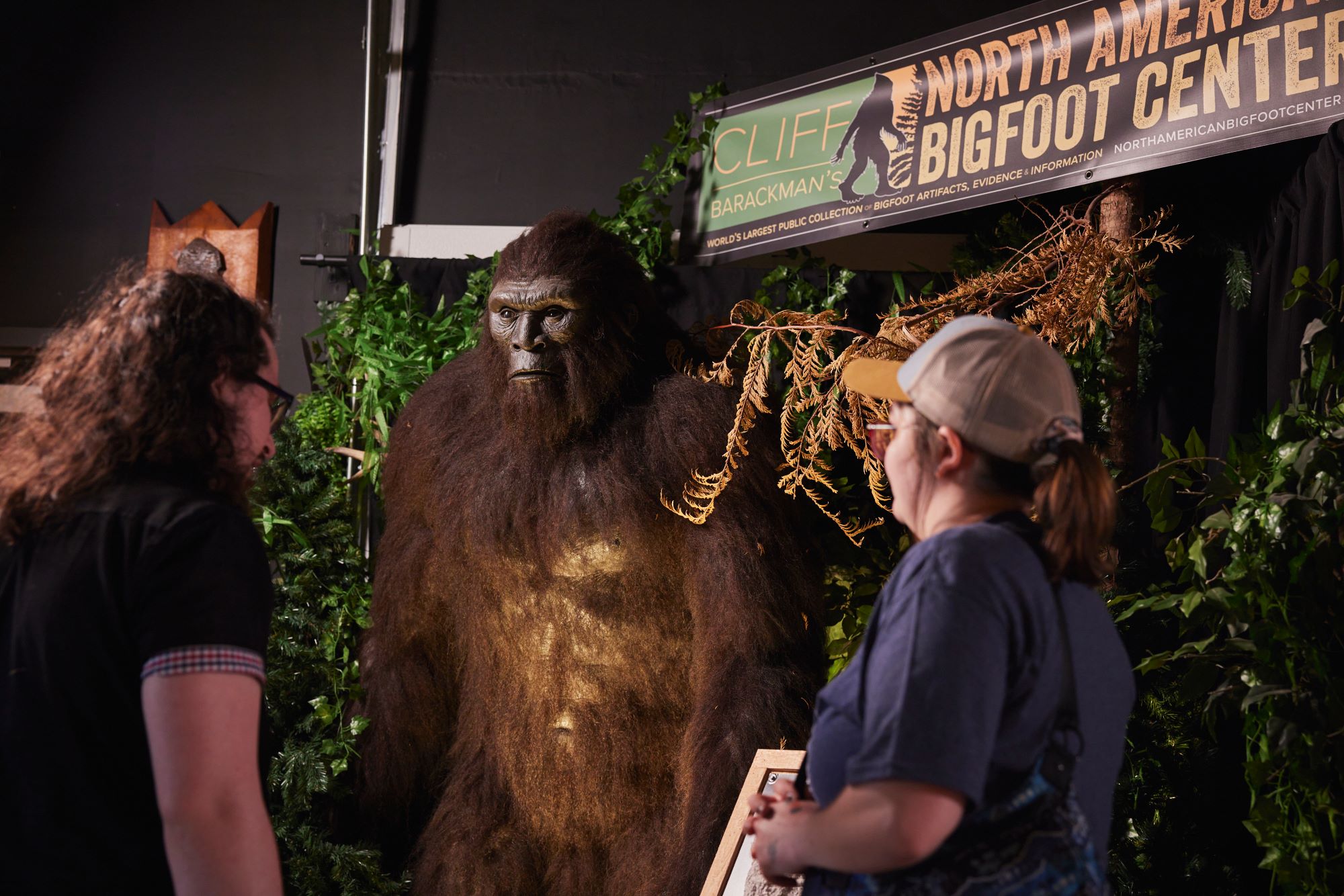 Two visitors look at bigfoot at the North American Bigfoot Center