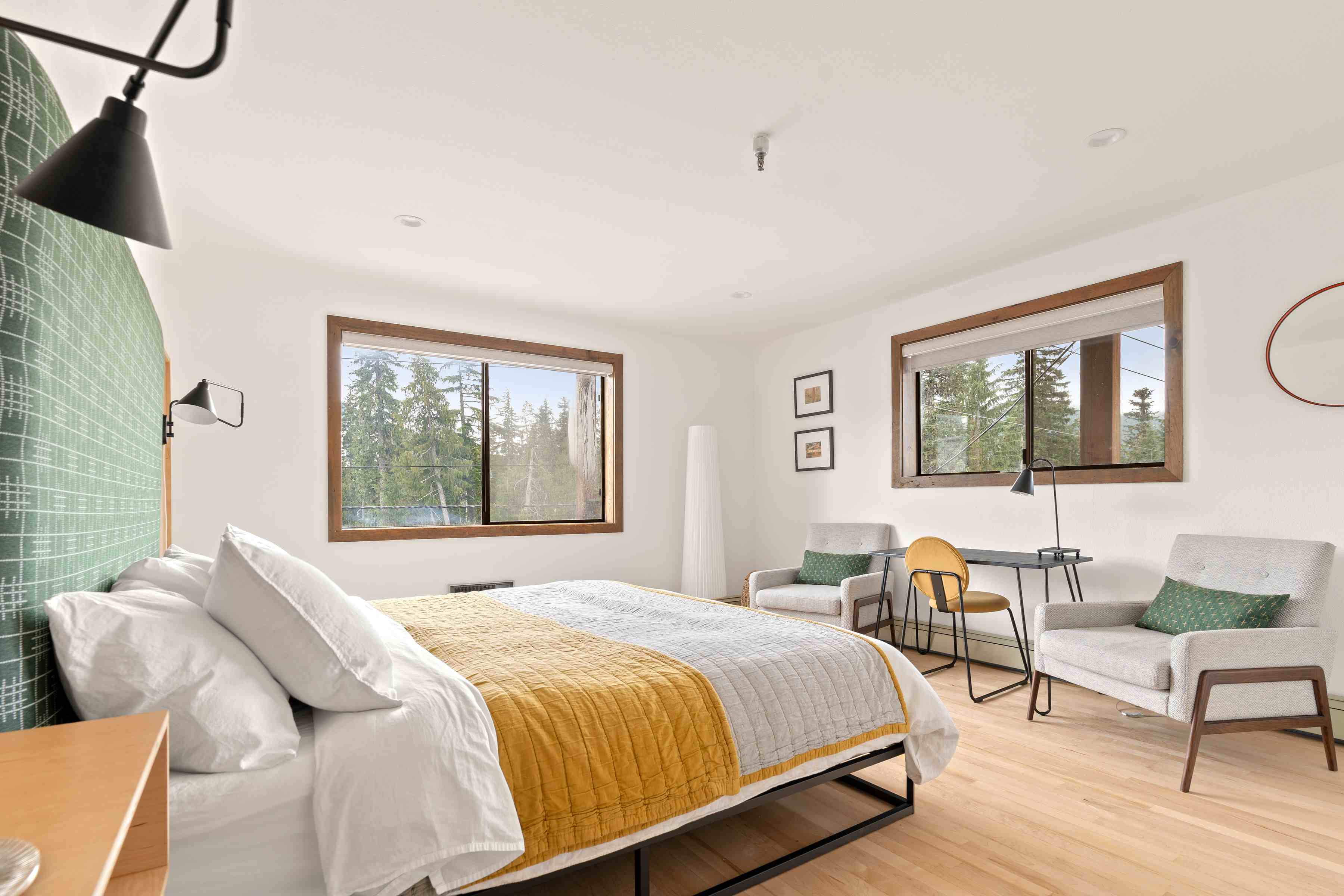 Primary bedroom at Alpine Ascent at Thunderhead Lodge is decorated is greens & shades of yellow.
