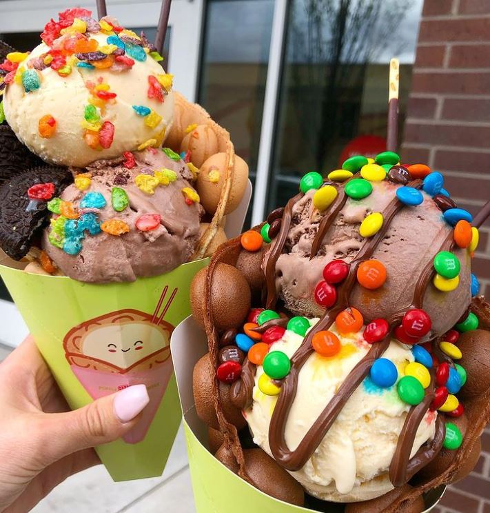 Two bubble waffles filled with vanilla & chocolate ice cream
