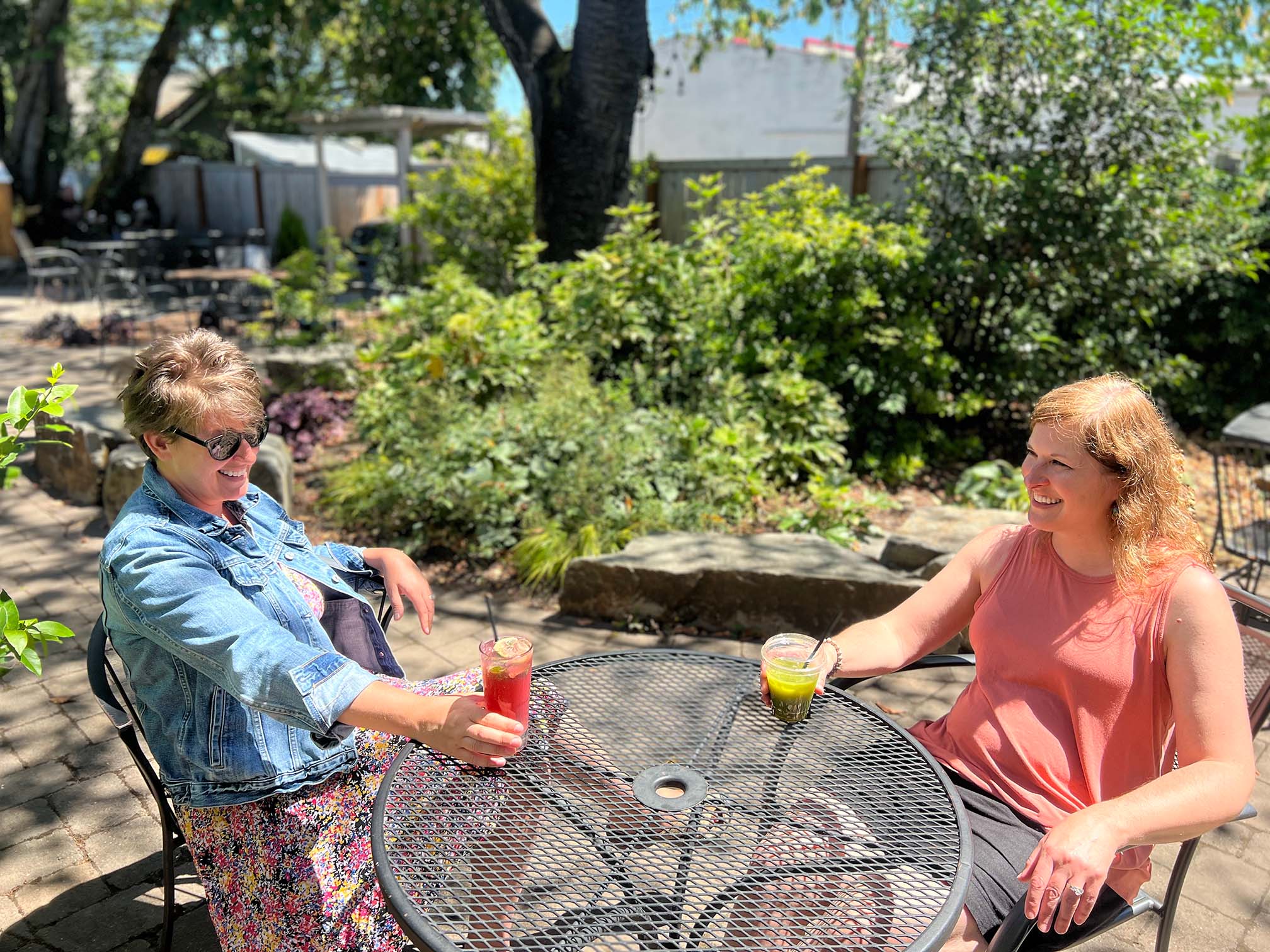 Two people sitting at a patio with teas