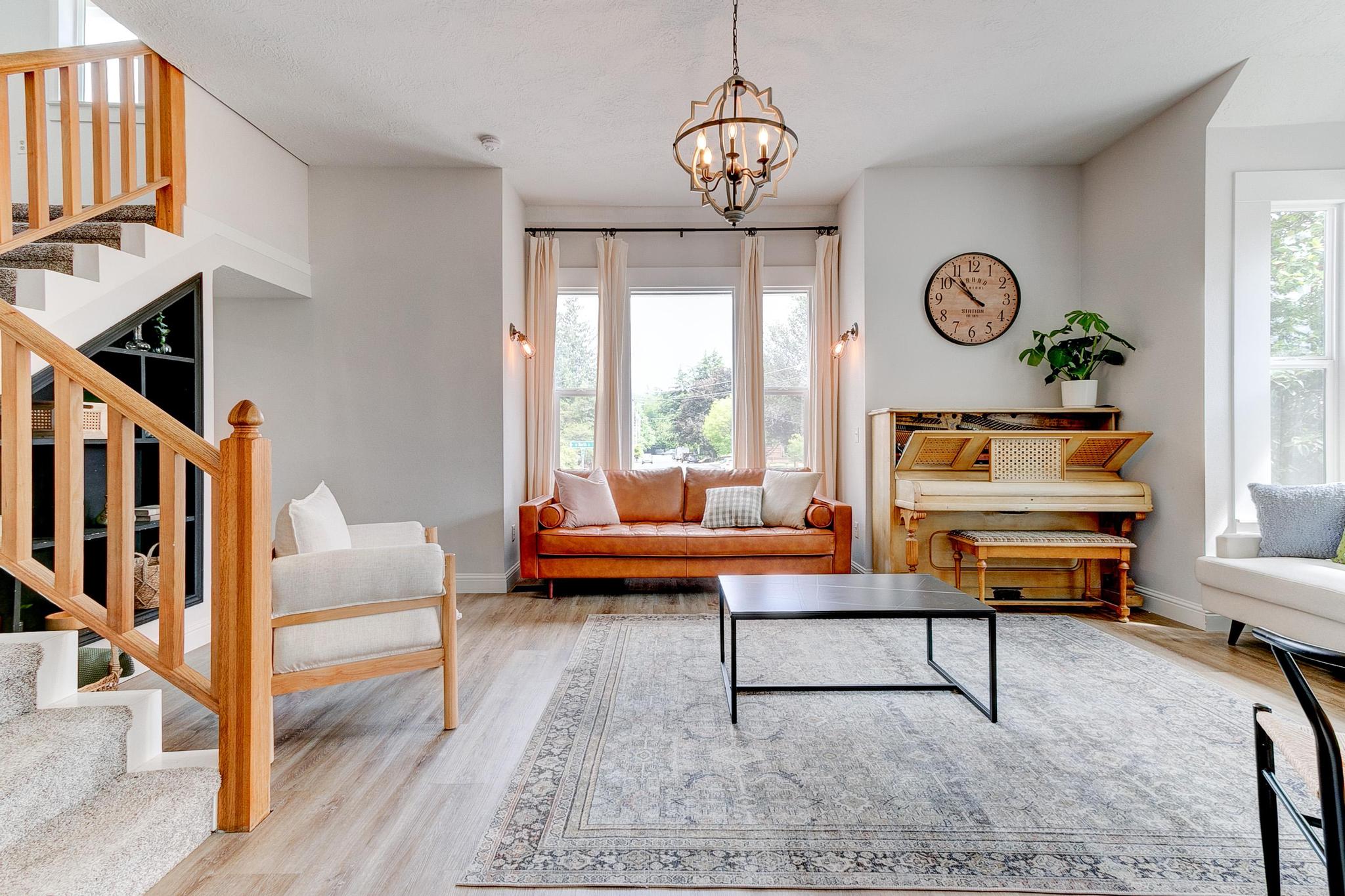 Living room with white walls, wood flooring, and furniture