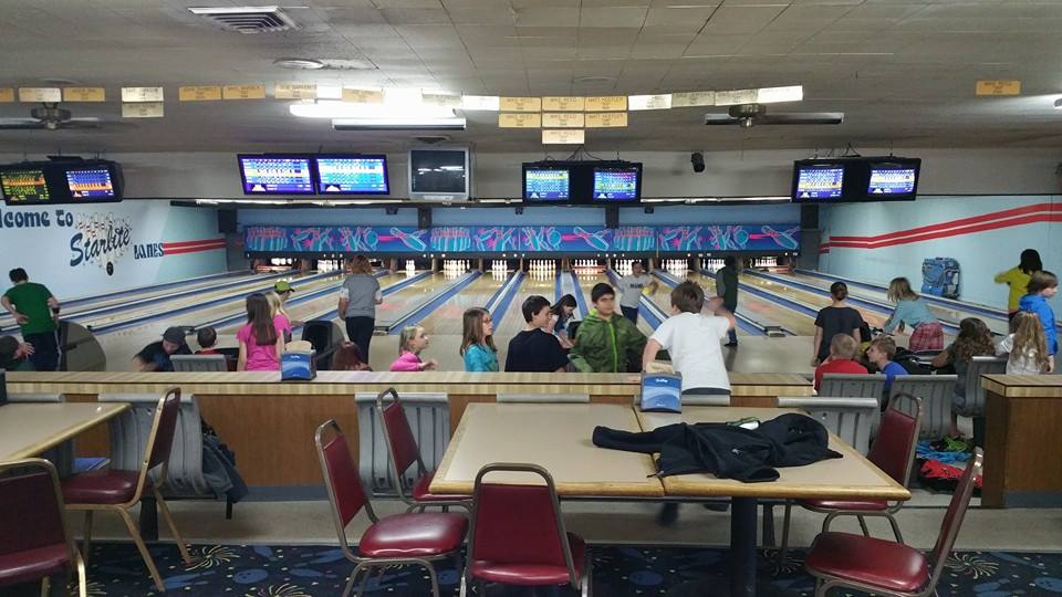 small groups of people in bowling alley
