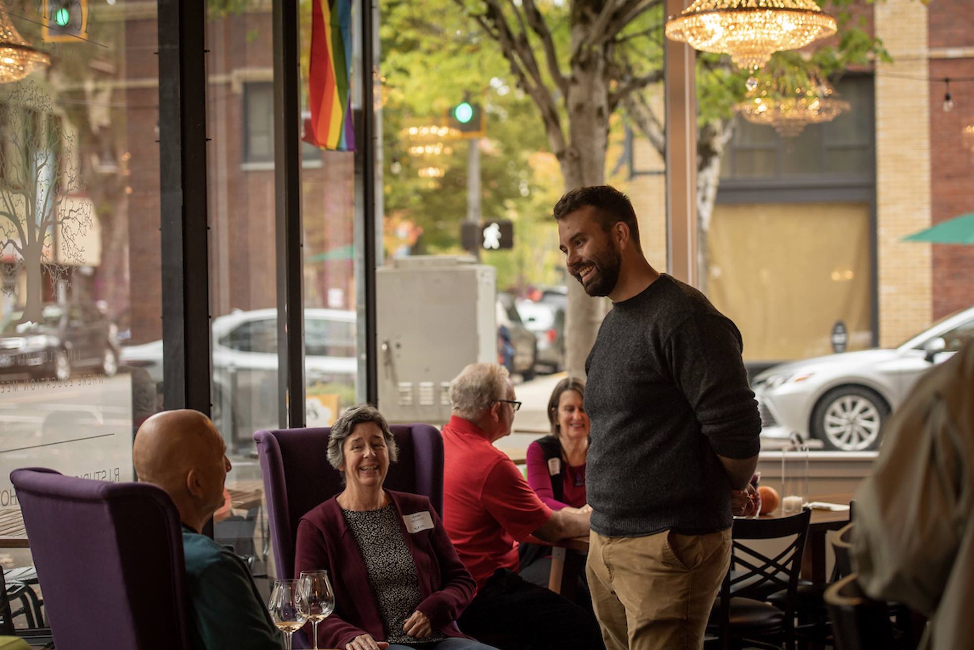 inside tasting room, owner speaks to patrons