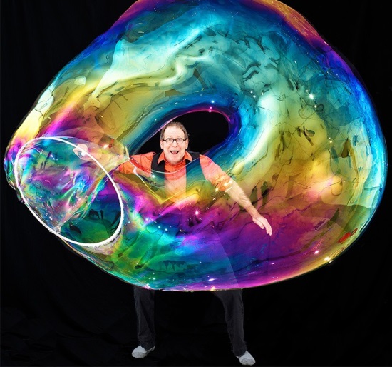 Person making a life size bubble