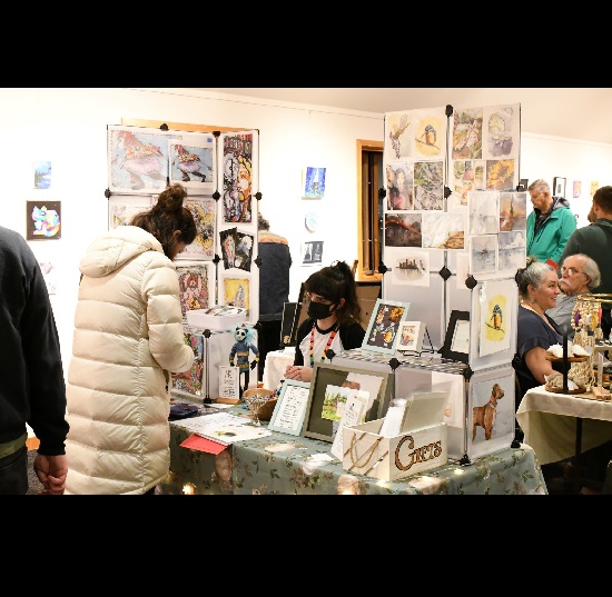 Person selling handmade goods at art fair