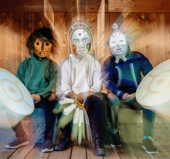 Three people in native masks