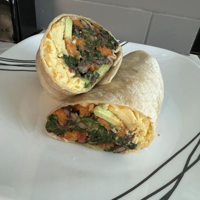 breakfast wrap cut in half on a plate