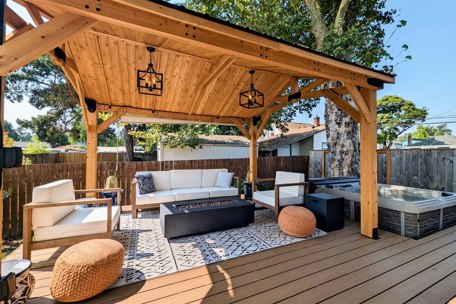 Backyard covered patio with outdoor seating and spa