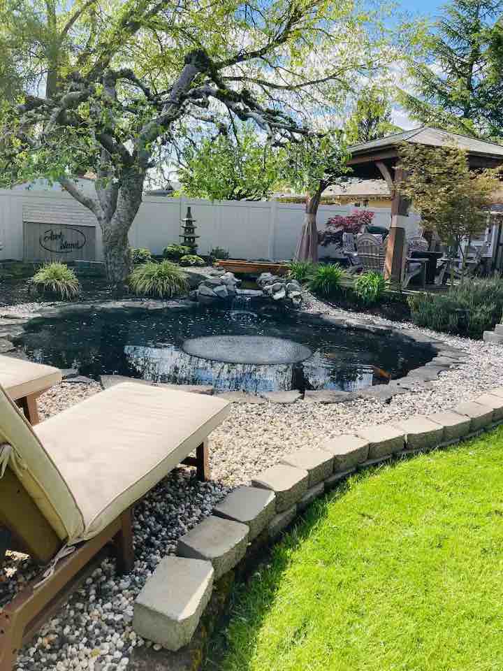 backyard with pond and covered patio