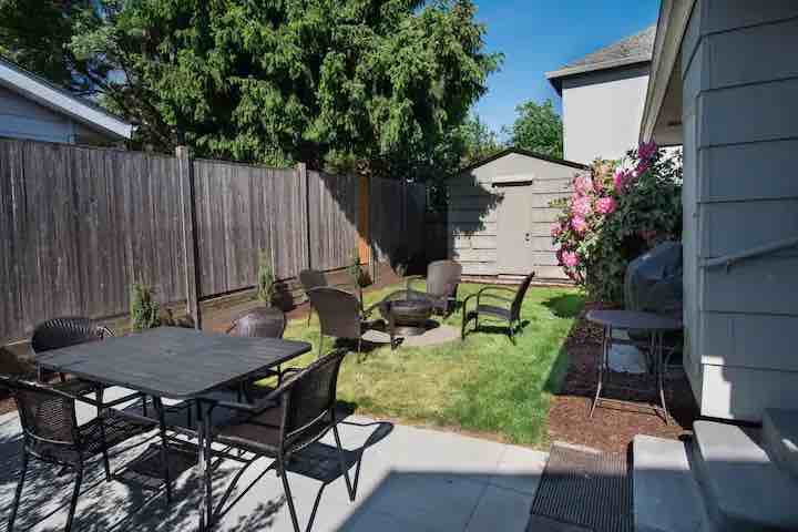 Backyard view of seating and shed