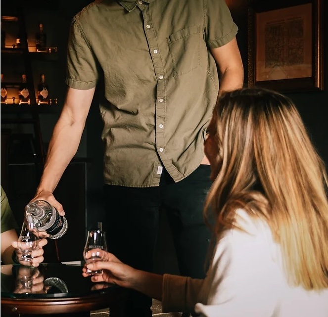Gentleman pouring a drink in the tasting room of Brixeur Spirits Distillery