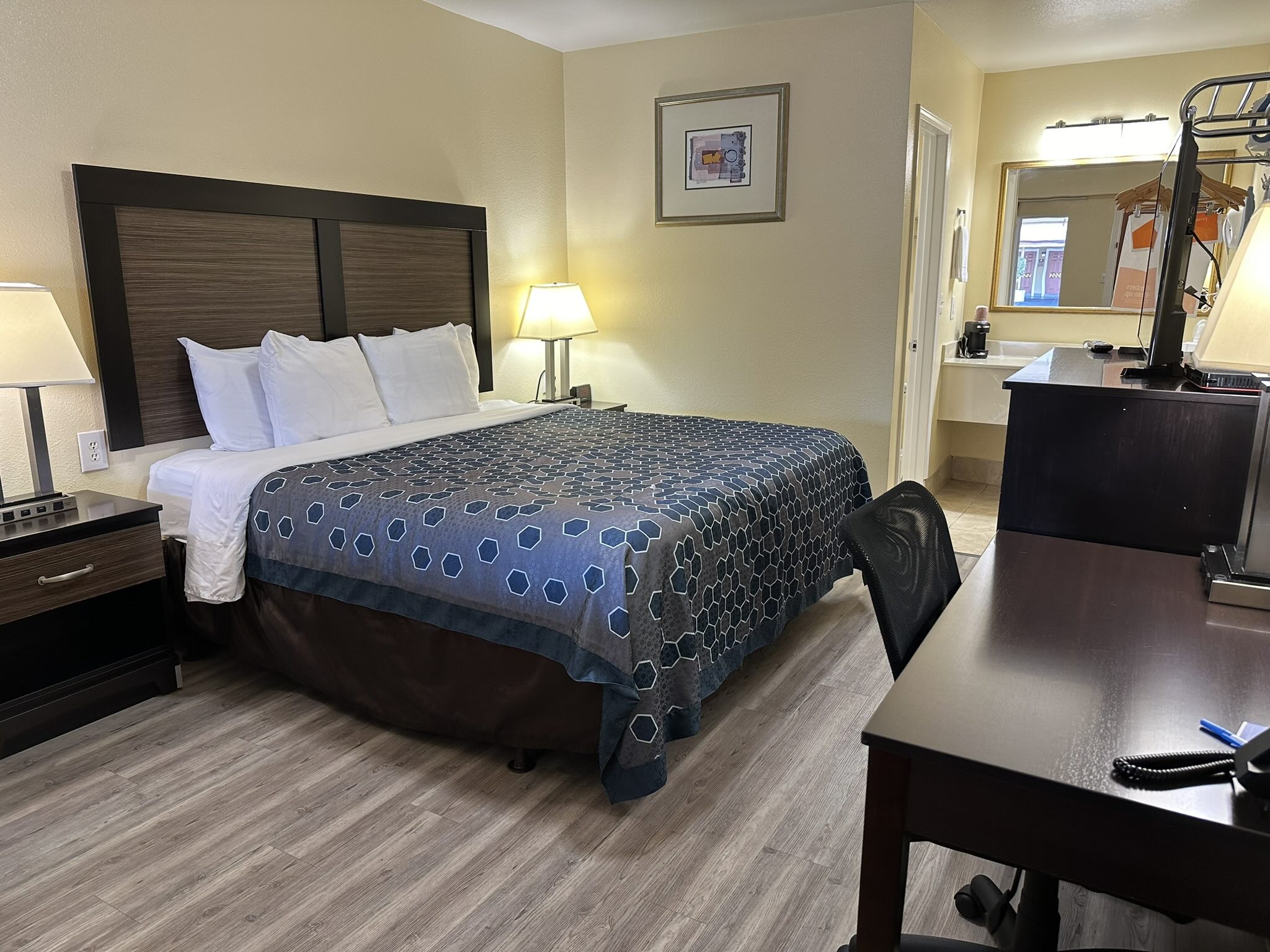 Hotel room with blue spotted bedding.