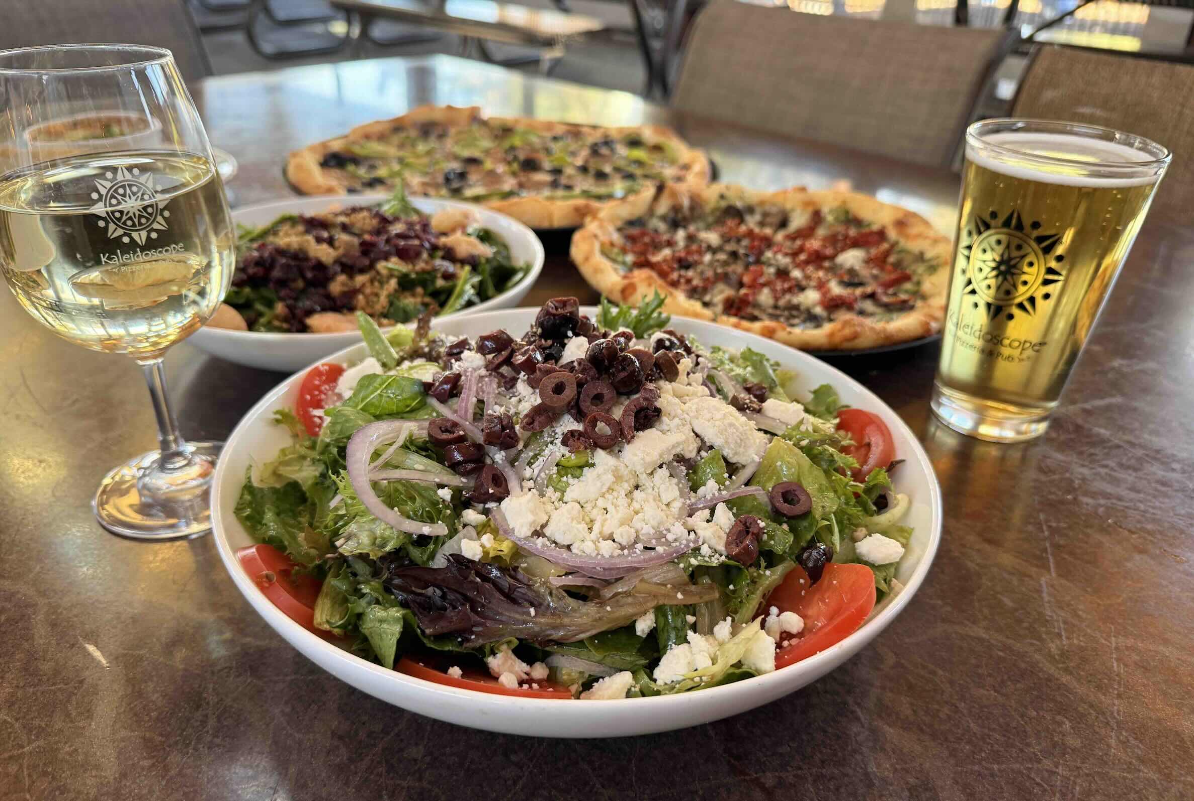 Fresh salads, pizza and drink.