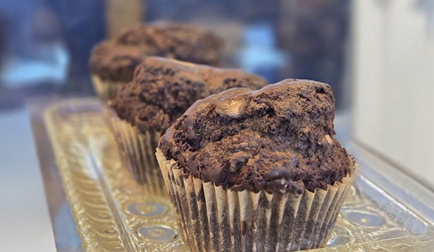 three chocolate muffins on a fancy tray
