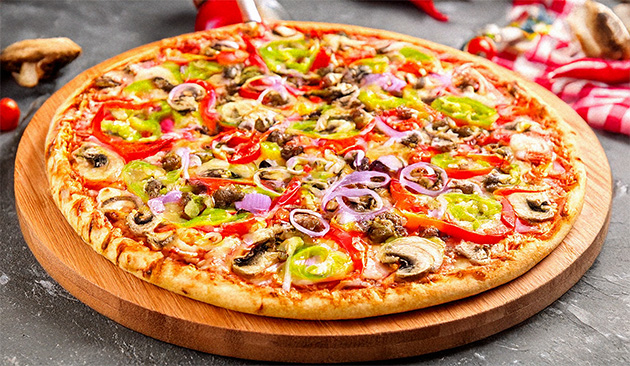 whole pizza on a round wooden board