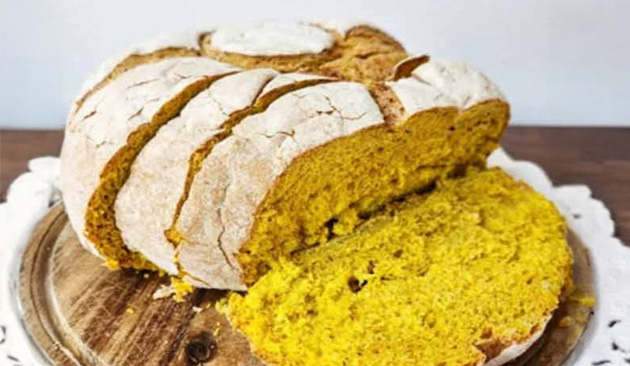 artisan loaf of bread cut in thick slices that are yellow in color