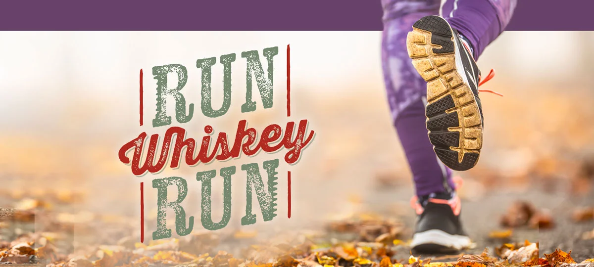 Graphic with the words "Run Whiskey Run" beside a close-up of a runner's legs and shoes on a leaf-covered trail, with one foot lifted mid-stride.