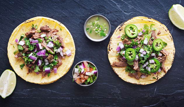 El Coyote street tacos topped with grilled beef, diced red onion, cilantro and sliced jalapeños, served with salsa, pico de gallo and fresh lime wedges.